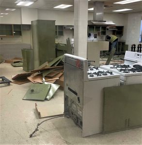 Construction workers complete demolition of the previous kitchen area space.