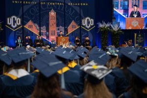 Graduates listening to speaker at commencement