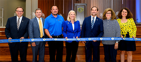 Image of the South Wing Ribbon Cutting and champagne toast took place on June 18, 2019. This was the last presidential act of Don Betz. Pictured are Provost John Barthell; Don Beck, Beck Design; Nick Bench, Lippert Brothers Construction; Susan Winchester, Chair of the Oklahoma Board of Regents; Former President Don Betz; Susanne Betz; and Dean Catherine Webster.