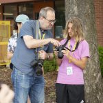 UCO Photography Professor Jesse Miller shows demonstrates camera settings to student