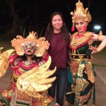 Anh Dinh poses with Balinese dancers