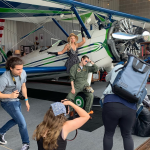 Students photograph models on airplane for UCO Photography Camp