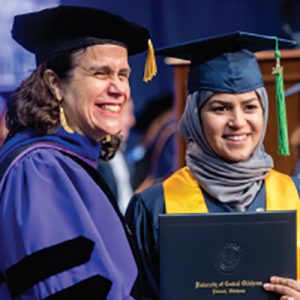 UCO Liberal Arts Dean Cathy Webster with student at Graduation Convocation