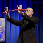 Dr. Stein at TEDxUCO, holding nunchucks