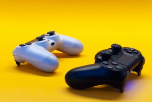 Two video game joysticks on yellow back ground