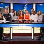 UCentral Media Studies pose for a photo around the UCentral News Desk.