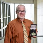 UCO professor John Wood with his award from DaVinci Institute